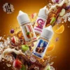 LH VAPEMY 馬來西亞系列尼古丁鹽煙油主圖。展示三款熱銷口味瓶身：Rude Beer (麥根沙士)、Grapple (葡萄蘋果) 與 Orange (鮮橙)。背景為棕色麥根沙士氣泡與冰塊爆炸特效，伴隨蘋果、葡萄與柳橙切片，強調馬來油的濃郁風格。